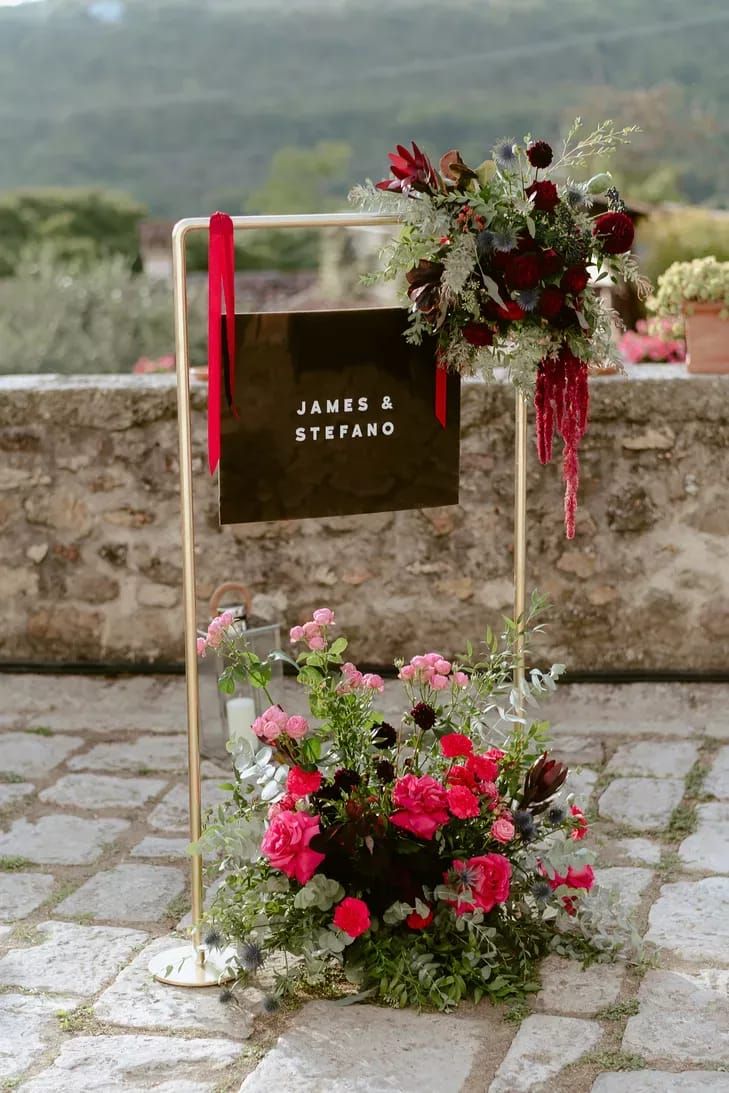 a sign that says james and stephanie on it with flowers in front of the sign