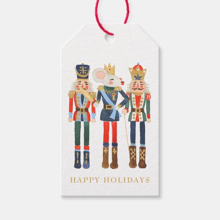 a christmas gift tag with three nutcrackers and the words happy holidays on it