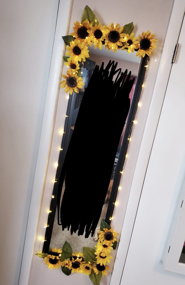 a mirror with sunflowers and lights on it