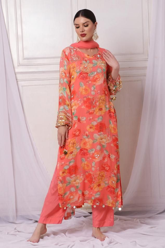 Pink georgette kurta with floral print and sequins, pearls, cutdana and stones embroidery. Comes with shantoon pant and a net dupatta.
Components: 3
Pattern: Printed, Embroidered
Type Of Work: Floral, Sequins, Pearls, Cutdana
Neckline: Leaf Neck
Sleeve Type: Full
Fabric: Kurta : Georgette, Pant : Shantoon, Dupatta : Net, Lining : Shantoon
Color: Pink
Other Details: 
Attached lining
Length :
Kurta : 50 inches
Pant : 38 inches
Product Weight : 1 Kg
Closure : Kurta - Back hook
Occasion: Sangeet - A Semi-stitched Georgette Sets With Sequins, Designer Georgette Kurta With Sequins, Designer Georgette Sequin Kurta, Spring Designer Salwar Kameez With Mirror Work, Spring Salwar Kameez With Mirror Work And Long Sleeves, Spring Anarkali Salwar Kameez With Mirror Work, Long Sleeve Georgette Salwar Kameez With Sequins, Spring Long Sleeve Salwar Kameez With Mirror Work, Summer Georgette Kurta With Mirror Work