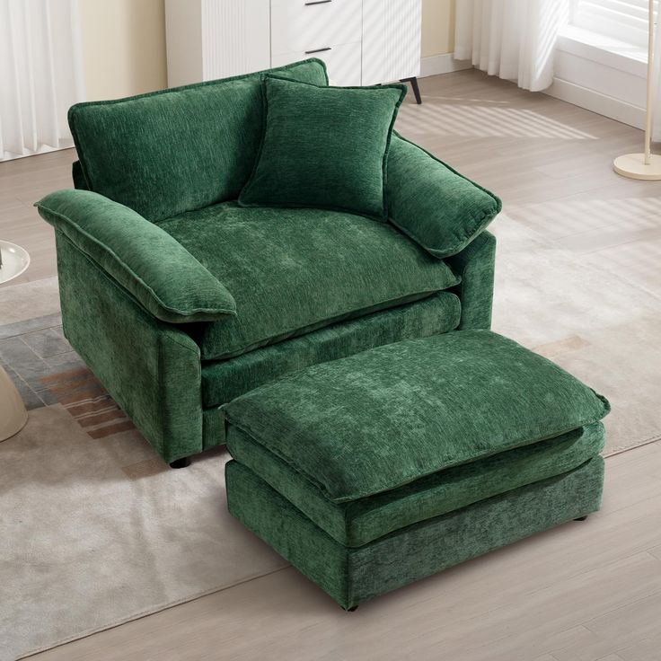 a green chair and ottoman in a living room