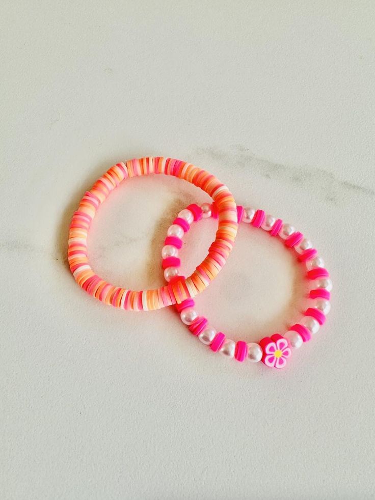 Orange and pink clay bead bracelets. Cheap Pink Polymer Clay Beaded Bracelets, Pink Beaded Plastic Jewelry, Pink Plastic Round Bead Jewelry, Pink Plastic Round Beads Jewelry, Pink Plastic Round Beaded Jewelry, Pink Hand-strung Beads For Beach, Cute Pink Beaded Plastic Bracelets, Pink Hand-strung Heishi Beads Friendship Bracelets, Trendy Pink Spacer Beads