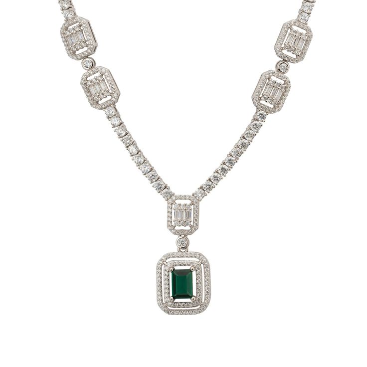 Elevate your elegance with the Evita Emerald Statement Necklace in Silver. This exquisite piece redefines luxury with its tennis necklace design. The centrepiece is a breath-taking pendant drop, featuring two distinct rectangular settings. The larger setting cradles a stunning lab-grown emerald, enveloped by two dazzling rows of zircons. This masterpiece gracefully connects to a smaller rectangular setting, where baguette-cut zircons are framed by a single row of glistening zircons.  Adding to i Elegant Baguette Cut Emerald Necklace For Formal Events, Elegant Baguette Cut Emerald Necklace For Formal Occasions, Elegant Gemstone Tennis Necklace For Anniversary, Luxury Rectangular Diamond Necklace, Luxury Rectangular Pendant Necklace For Wedding, Elegant Rectangular Necklaces For Formal Occasions, Elegant Formal Rectangular Necklace, Elegant Jewelry With Baguette Diamonds In Rectangular Shape, Elegant Rectangular Emerald Necklace For Formal Occasions