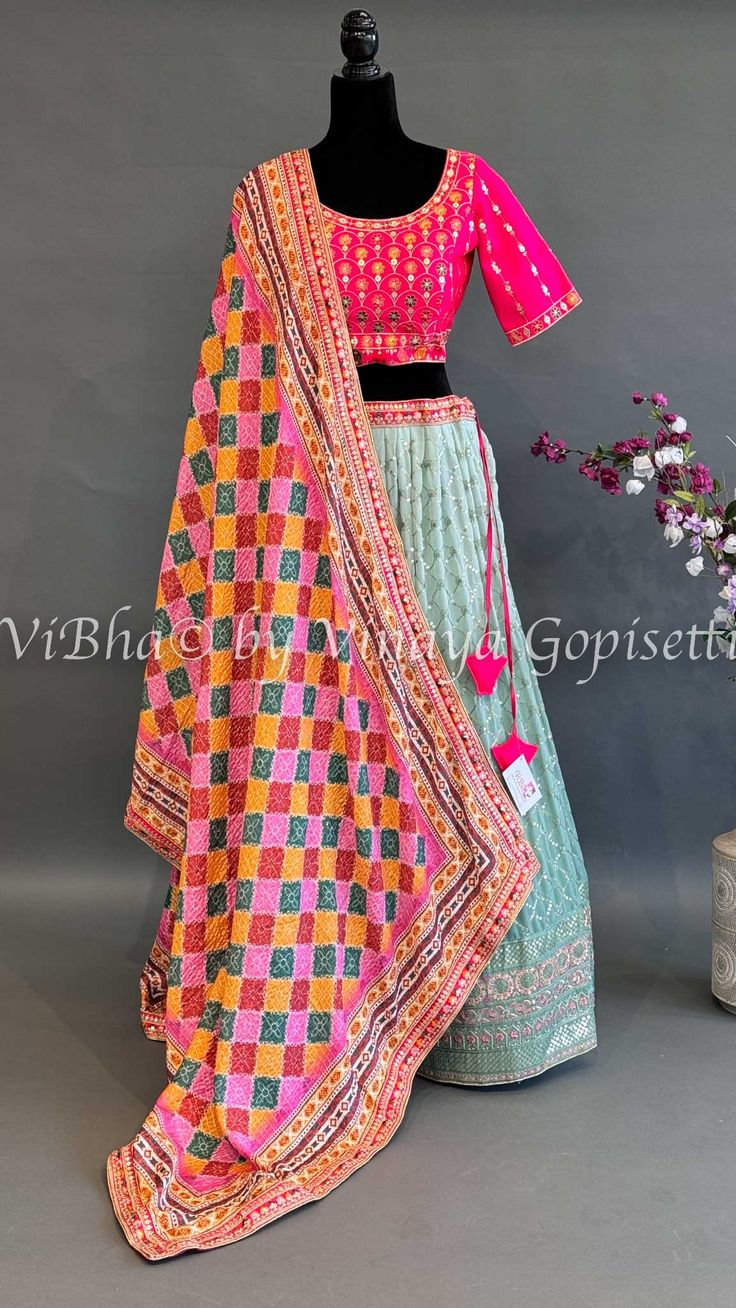 Enhance your style with our Mint And Hot Pink Embroidered Lehenga Set. This vibrant and beautiful ensemble features an elegant embroidered design and a patola print dupatta. Perfect for both day and evening occasions, this set will add a touch of sophistication to any look. Fitted Multicolor Embroidered Set For Reception, Fitted Set With Multicolor Embroidery For Reception, Fitted Sets With Multicolor Embroidery For Reception, Fitted Multicolor Embroidery Set For Reception, Fitted Embroidered Sharara For Festive Occasions, Anarkali Fitted Set With Multicolor Embroidery, Reception Salwar Kameez With Multicolor Embroidery, Fitted Bollywood Sharara With Multicolor Embroidery, Bollywood Style Fitted Sharara With Multicolor Embroidery