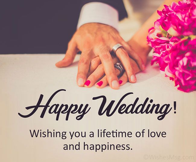 a couple holding hands on top of a table next to a bouquet of flowers with the words happy wedding wishing you a life time of love and happiness