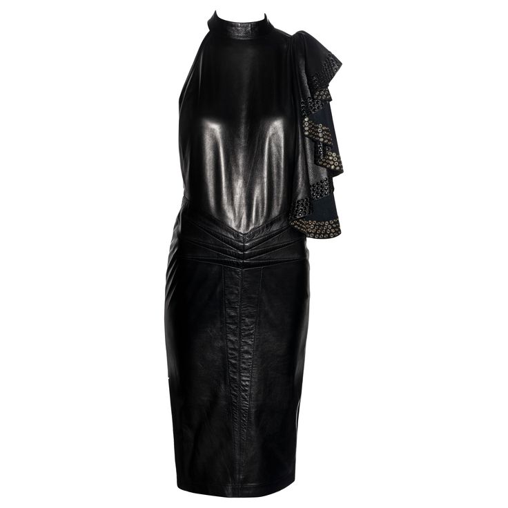 ▪ Important and early Azzedine Alaia black leather dress ▪ Museum grade ▪ Draped panel embellished with metal eyelets ▪ Choker neck ▪ One strap connecting the shoulder to the waist ▪ Corset-style lace fastening at the center-back waist ▪ Six darts at the center-front waist ▪ Mid-length pencil skirt ▪ Size: FR 38 ▪ Spring-Summer 1981 Alaia Vintage, Black Leather Dress, Panel Skirt, Wool Knitted Dress, Jersey Wrap Dress, Black Long Sleeve Sweater, Black Leather Dresses, Azzedine Alaia, Red Bodycon Dress