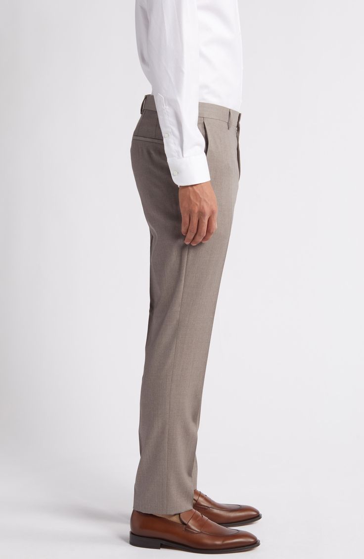 Sharpen up your wardrobe with these dress pants crafted from polished wool with a flat front and smart creases down the legs. 34" inseam; 14" leg opening; 10 1/2" front rise; 17" back rise (size 34) Unhemmed Lined to the knee 100% wool Dry clean Imported Hugo Boss/BOSS/HUGO has received the Fair Labor Association accreditation, which signifies that the company has effective systems and procedures in place to successfully uphold fair labor standards throughout its supply chains, including strateg Tailored Semi-formal Bottoms In Suiting Fabric, Tailored Business Bottoms In Suiting Fabric, Tailored Wool Dress Pants For Business, Wool Dress Pants For Business Casual With Tapered Leg, Tailored Bottoms In Suiting Fabric For Business, Slim Fit Wool Pants With Straight Hem, Tailored Wool Dress Pants For Business Casual, Tailored Wool Dress Pants For Semi-formal Occasions, Classic Tailored Tapered Leg Dress Pants