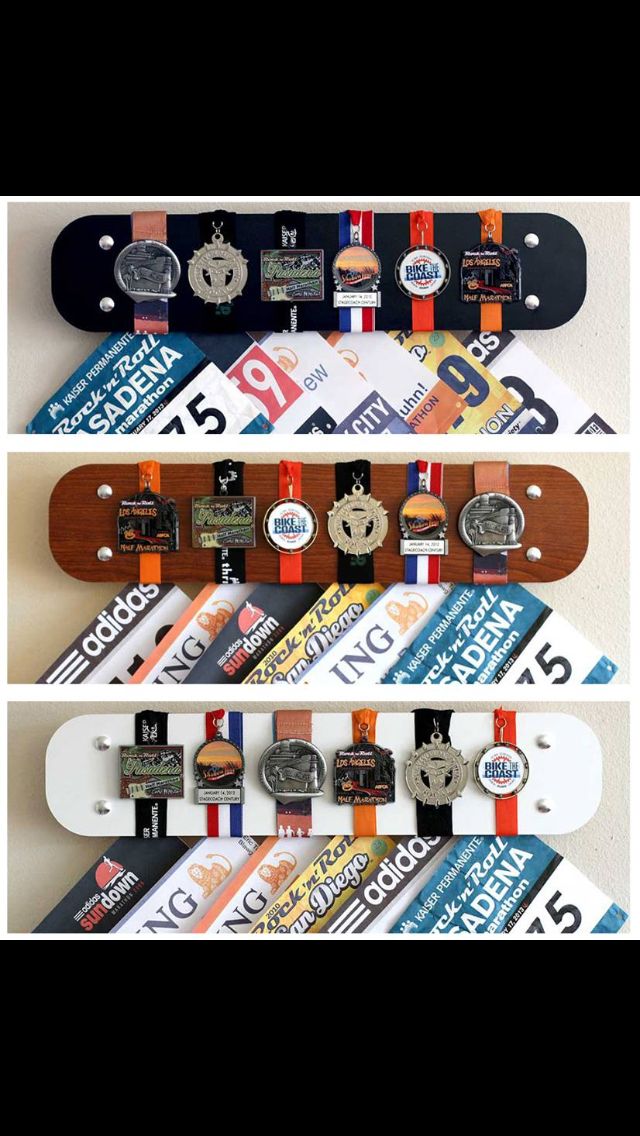 three skateboards are stacked on top of each other with medals attached to the boards