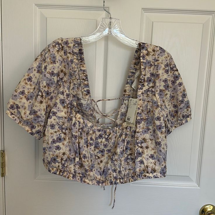 Brand New Never Worn. Tie Closure In The Back. Perfect Condition Floral Print Lavender Top For Vacation, Lavender Floral Print Top For Vacation, Lavender Floral Print Tops For Day Out, H&m Floral Print Tops For Day Out, Black Flannel Shirt, White Polka Dot Top, Brown Zip Ups, H&m Blouse, Black Flannel