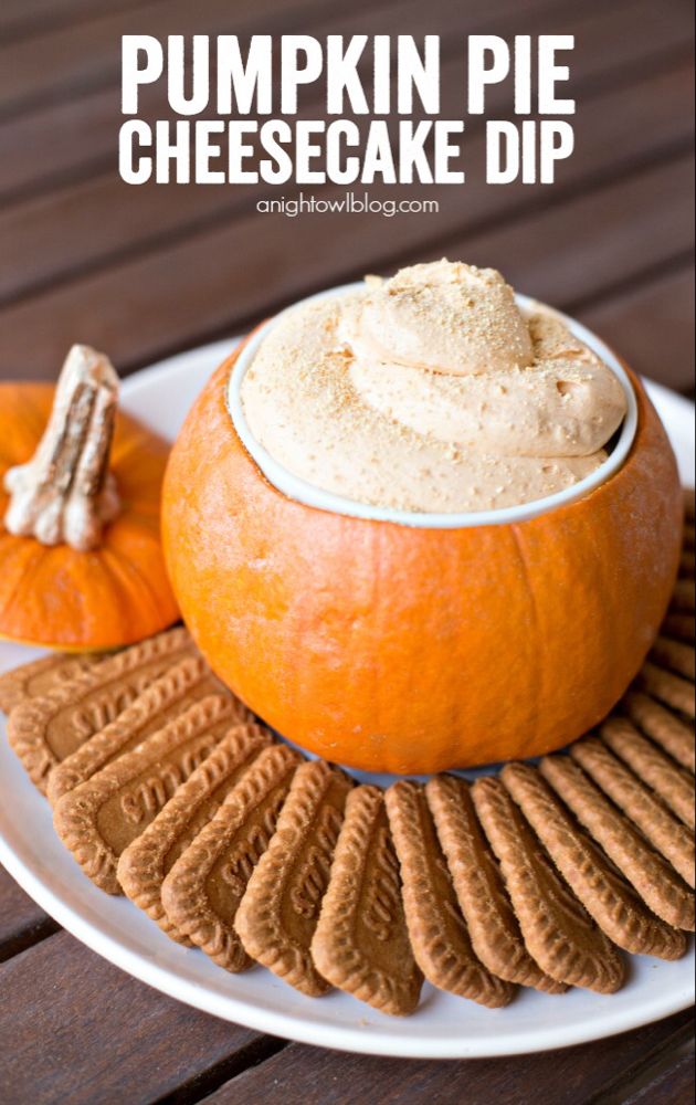 a pumpkin pie cheesecake dip on a plate with crackers