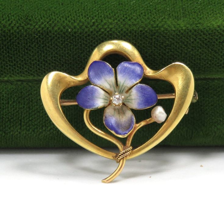 "Art Nouveau/1900 14k yellow gold hand enameling .05 carat natural diamond H in color 1\" x 1\" condition: excellent Beautiful Art Nouveau flower brooch, crafted of 14 karat yellow gold and set with hand enameling and a natural diamond.  The brooch is a nice size, measuring 1\" x 1\", and features a lavender flower delicately detailed in enamel, with a .05 carat natural diamond H in color set at the center.   The brooch is in excellent condition, with no damage to the gemstone or enamel loss.  I Yellow Gold Enamel Brooches Hallmarked, Art Deco Yellow Gold Collectible Brooches, Yellow Gold Enamel Brooches, Art Nouveau Enamel Brooch Jewelry, Art Deco Yellow Gold Hallmarked Brooches, Gold Enamel Art Nouveau Jewelry, Art Nouveau Gold Enamel Jewelry, Art Nouveau Wedding Brooches Hallmarked, Collectible Art Nouveau Hallmarked Brooch