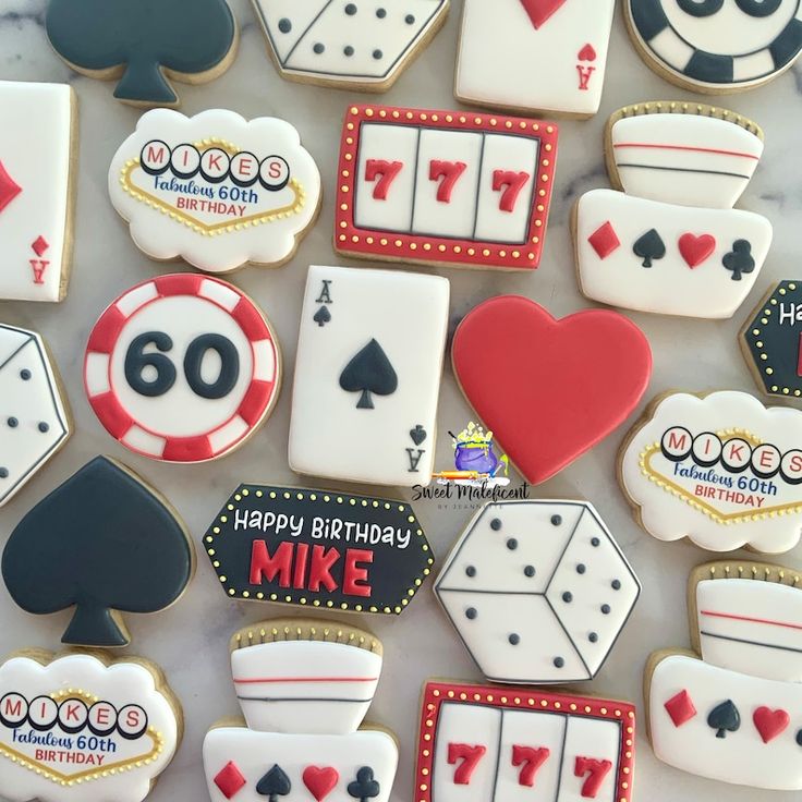 decorated cookies are arranged in the shape of playing cards