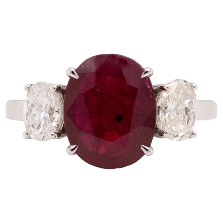 This exquisite 18kt two-tone ring showcases a 3.27 carat ruby embraced by oval diamond accents, evoking timeless elegance and sophistication, making it a classic symbol of enduring beauty and luxury. the center ruby weighs 3.27ct and the two ovals weigh 0.93ct. the diamonds are G color and Si2 clarity. the ring is marked 18kt. Ruby Diamond Ring, Ruby Diamond Rings, Large Gift, Ruby Diamond, Ruby Ring, Oval Diamond, Cocktail Rings, Timeless Elegance, Two Tone