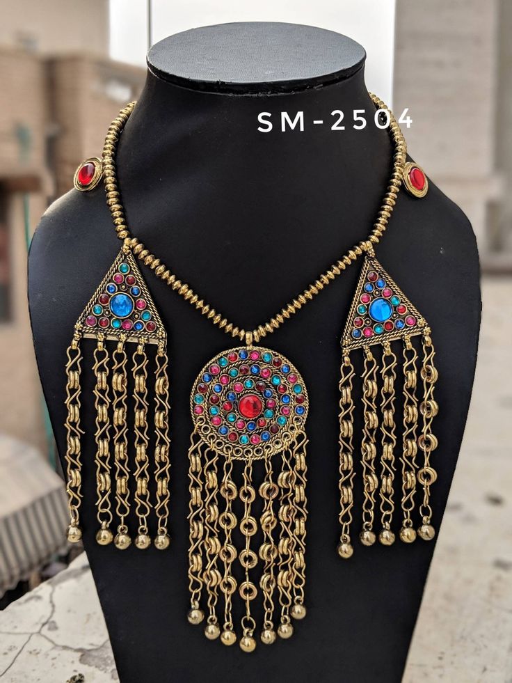 Add charm and charisma to your beautiful personality with this exquisitely designed and handcrafted Afghani necklace studded with glass stones. Pair it up with any casual, semi formal or, formal attire and gather compliments for your unique and classy choice. Ideal wear for both casual and dressy occasions Weight 120 GM's Length 12 inches Adjustable length with a black thread at the back Note: All in stock items will be shipped from New Delhi, India within 2-3 business days after receipt of paym Bohemian Gold Kundan Necklace With Stone Work, Gold Bohemian Kundan Necklace With Stone Work, Handmade Pendant Temple Necklace For Festival, Bohemian Pendant Necklaces For Rituals, Bohemian Brass Necklaces For Festival, Bohemian Brass Necklace For Festivals, Handmade Temple Necklace With Pendant For Festival, Bohemian Gold Kundan Beaded Necklaces, Bohemian Kundan Necklace With Stone Work