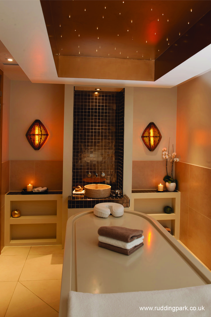 a spa room with candles and towels on the counter