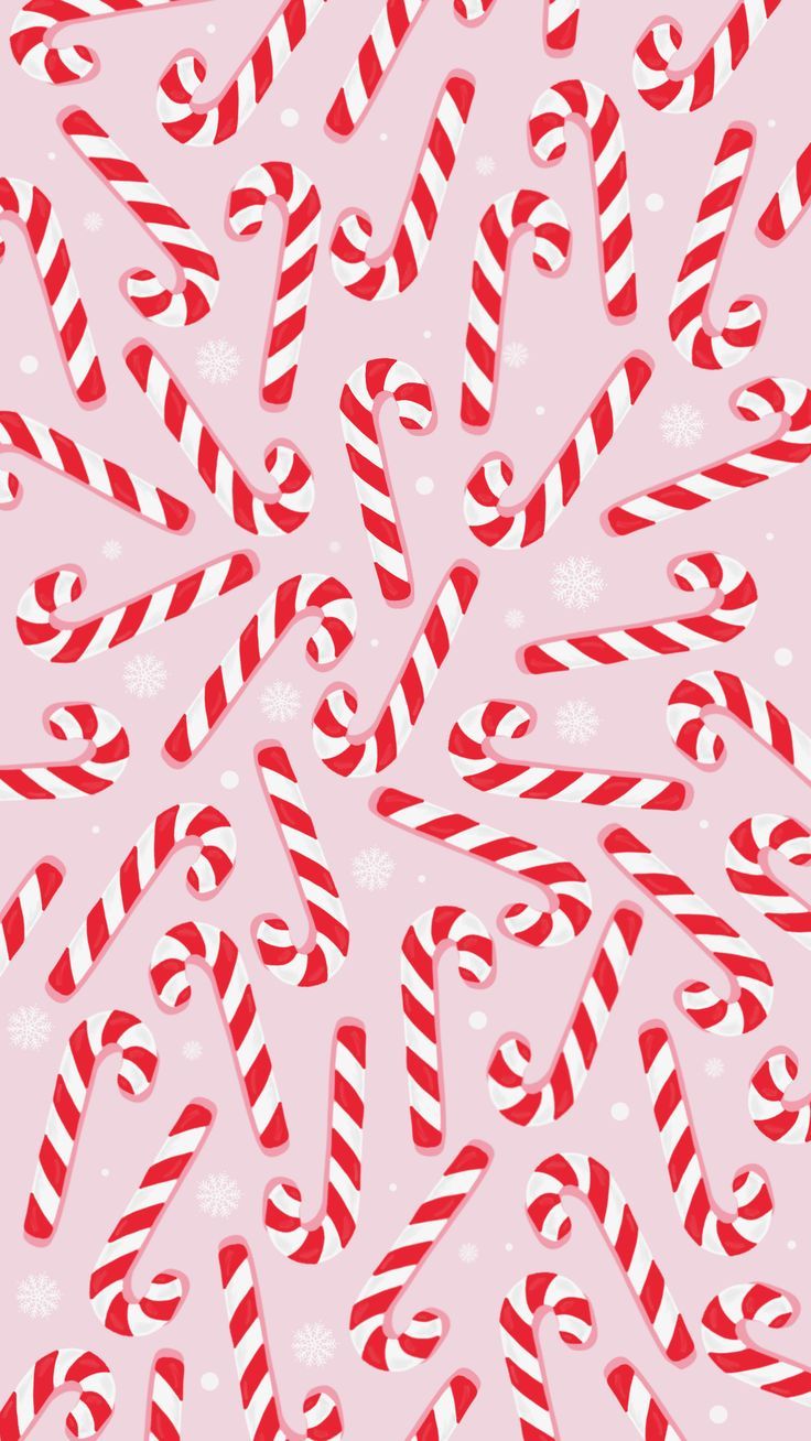 candy canes and snowflakes on a pink background