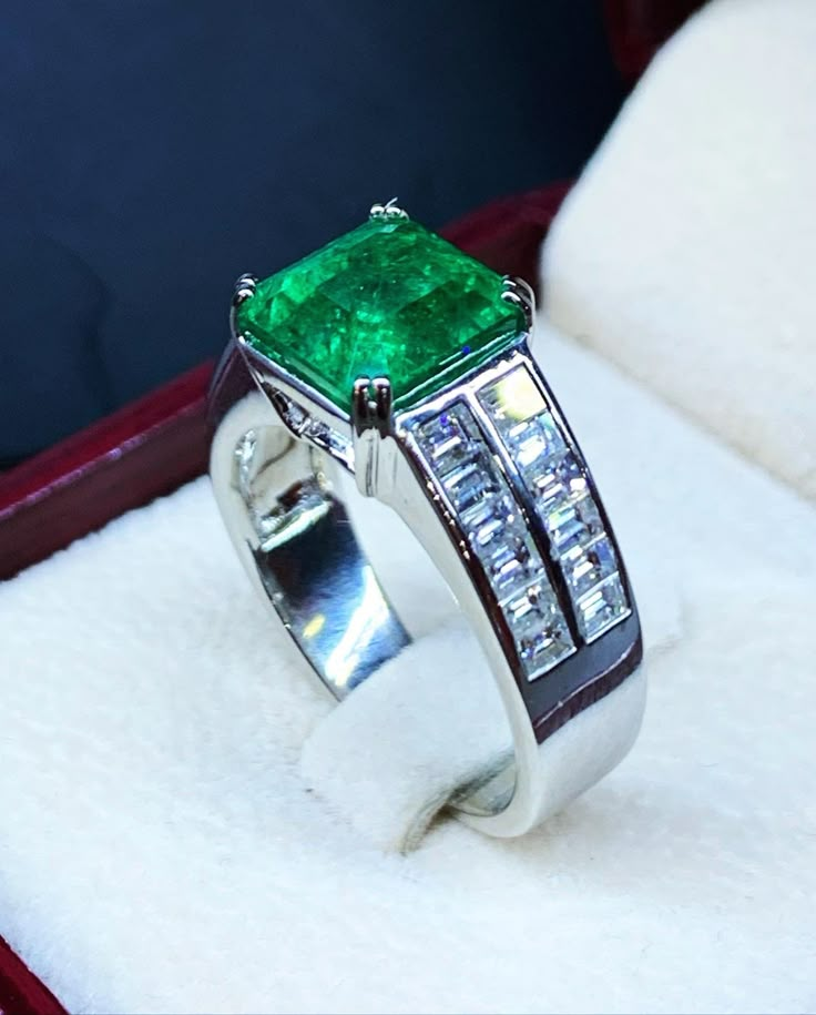 BRAND-NEW!! ONE OF A KIND, HANDCRAFTED RING. EXQUISITE AND FINE CRAFTSMANSHIP! HANDMADE TO LAST FOR AN ETERNITY!! HEIRLOOM PIECE!! PRECIOUS JEWELRY TO BE PASSED ON! PERFECT DRESS RING FOR A GENTLEMAN OR A LADY! 5.34 total carat weight, Certified, Natural emerald ring. This ring offers an important statement of who you are with a 4.04 carats, VIVID DARK GREEN, transparent, ZAMBIAN EMERALD. Accentuating the EMERALD are the 24 SUBSTANTIAL E/VS, sparkling natural BAGUETTE diamonds SUGGESTED RETAIL V Smaragd Ring, Groom Ring, Natural Emerald Rings, Mens Gemstone Rings, Baguette Diamonds, Zambian Emerald, Colombian Emeralds, Men Diamond Ring, Handcrafted Rings