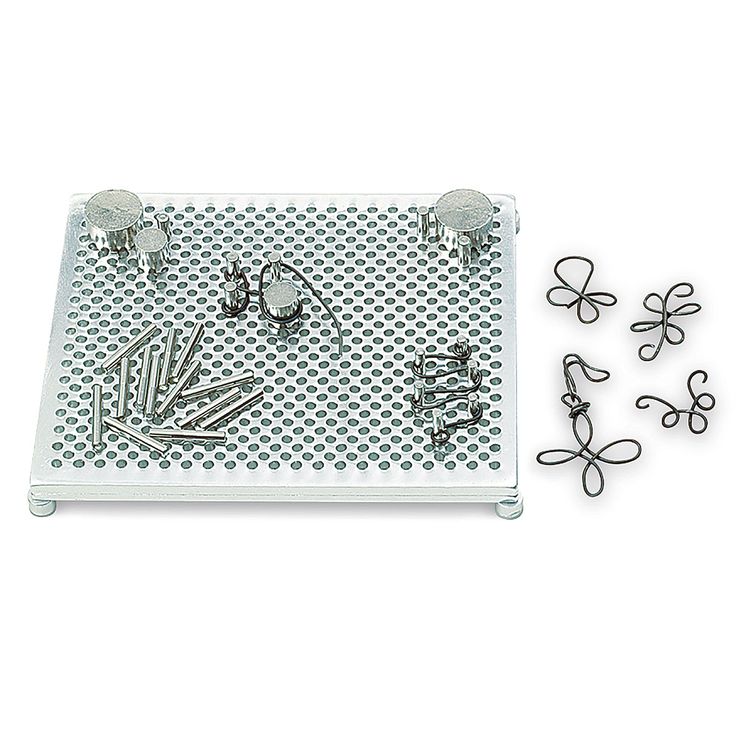 several metal objects are placed on a white surface with holes in the middle to make them look like they have been made out of paper