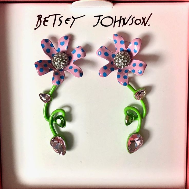 These Whimsical Earrings Feature A Pink Polka Dot Flower Adorned With Glistening Pave, And A Flowy Green Stem With Colored Stones. These Enchanted Earrings Are Set In Polished Gold-Tone Metal And Have A Post-Back Closure Set In Gold-Tone Metal With Glass Stones 2.25" L X 0.8” W Post-Back Closure Spring Flower Charm Jewelry For Parties, Spring Party Jewelry With Flower Charm, Purple Earrings For Spring Party, Whimsical Spring Earrings With Flower Charm, Whimsical Pink Earrings With Flower Charm, Pink Whimsical Flower Charm Earrings, Pink Whimsical Flower Earrings For Pierced Ears, Purple Flower Earrings For Spring Party, Pink Whimsical Flower Earrings With Flower Charm