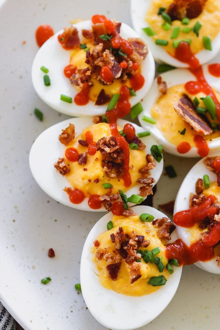 several deviled eggs are arranged on a white plate