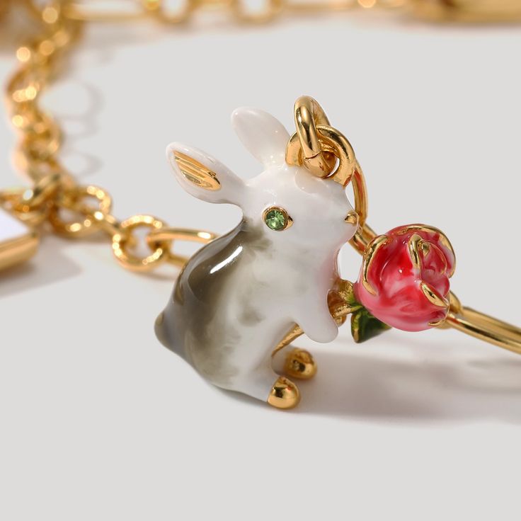 Unlock the secret of timeless style with Secret Garden Rabbit Bracelet. Meticulously crafted with an elegant poker charm and subtly lustrous enamel, this exquisite adornment is the epitome of tasteful luxury. A heartfelt addition to any jewelry collection. DETAILS Plating: 18K Gold Materials: 18K Gold on Brass Size:  8.03 "/20.4cm Weight:  10.1g Hypoallergenic design Elegant Enamel Jewelry With Lobster Clasp, Elegant Rose Gold Enamel Jewelry, Elegant Vintage Enamel Jewelry With Charm, Elegant Enamel Jewelry With Vintage Charm, Luxury Vintage Charm Bracelet As Gift, Valentine's Day Enamel Charms Jewelry, Valentine's Day Enamel Jewelry With Charms, Luxury Jewelry With Dangling Charms For Gifts, Luxury Dangling Charms Jewelry For Gifts