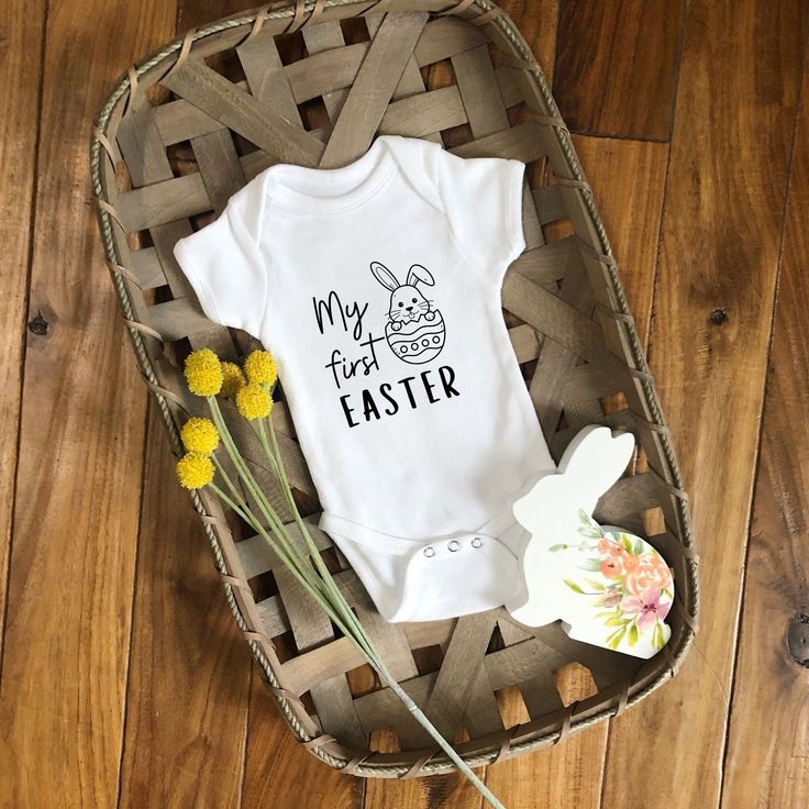 a baby's first easter outfit and flowers on a basket