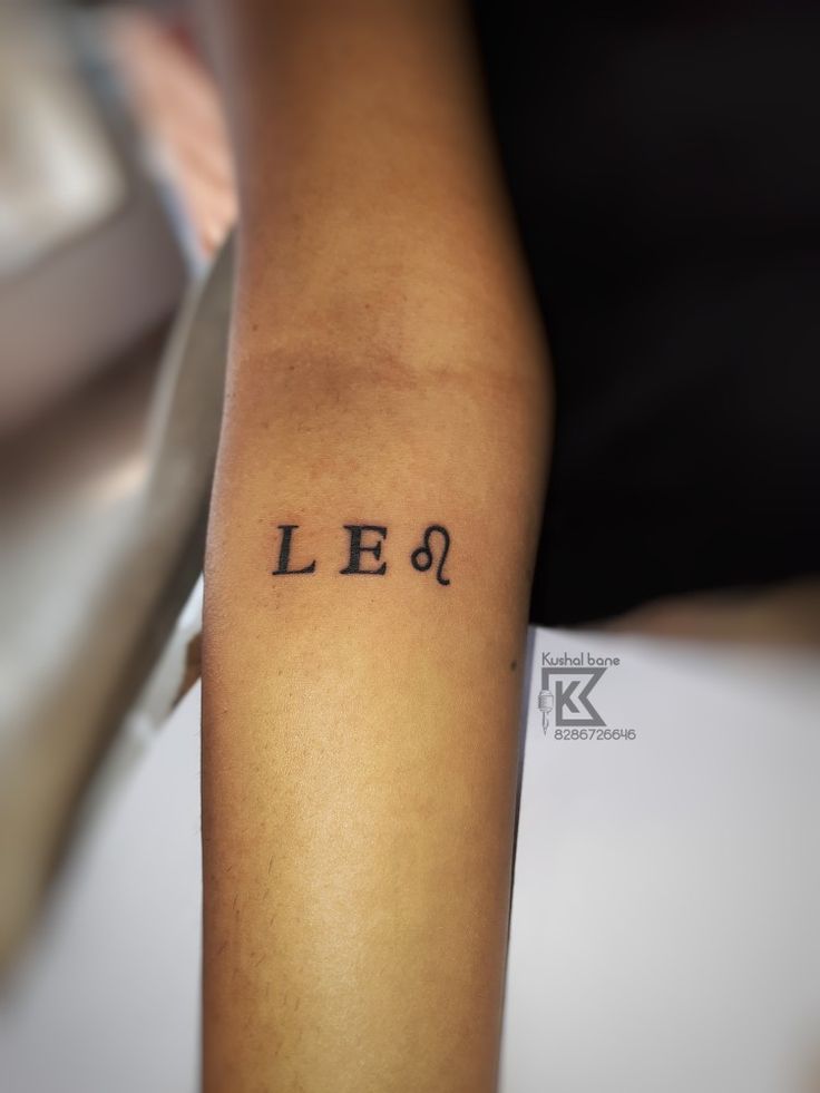 a person with a tattoo on their arm that says le 6, and the word lee is in cursive font