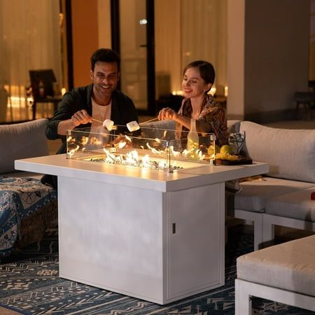 two people sitting at a table with candles on it