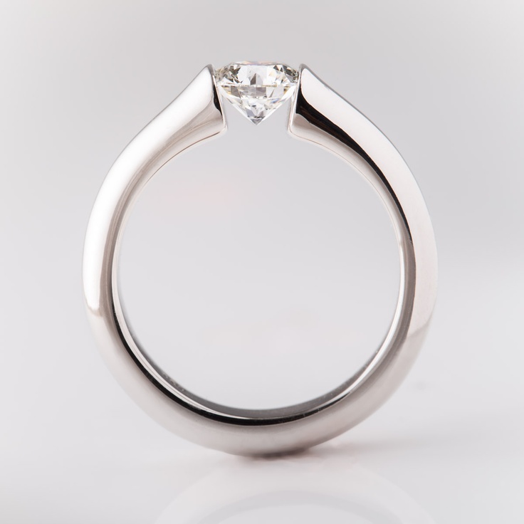 a white gold ring with a single diamond