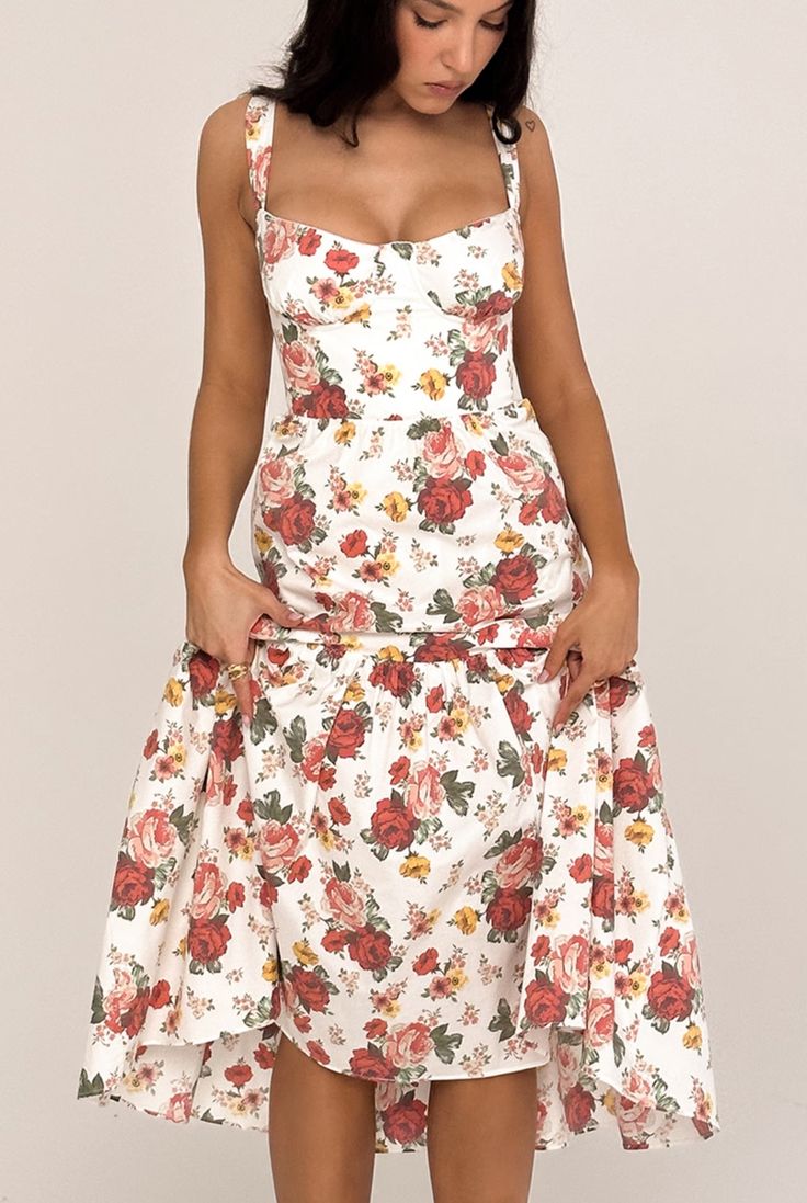 Why You'll Love It: Introducing our stunning Marielle Floral Midi Dress, a perfect blend of timeless elegance and modern charm. Crafted with meticulous attention to detail, this dress features a beautiful array of delicate florals that evoke a sense of romantic nostalgia. The flattering midi length offers a sophisticated silhouette that gracefully skims the body, while the lightweight fabric ensures comfort and ease of movement. A cinched waist enhances your natural curves, and the soft, flowing Chic Floral Midi Dress With Fitted Bodice, Sleeveless Fitted Midi Dress With Rose Print, Fitted Sleeveless Rose Print Midi Dress, Fitted Sleeveless Midi Dress With Rose Print, Elegant Floral Print Dress With Square Neck, Floral Print Midi Dress With Fitted Bodice, Fitted Midi Floral Dress For Garden Party, Fitted Floral Print Midi Dress For Casual Wear, Fitted Floral Print Midi Dress For Dress Down