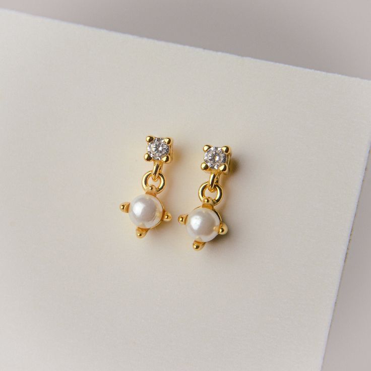 Crafted with 14k gold plating and a sterling silver base, these earrings feel as good as they look. Whether you're dressing up for a special occasion or simply accenting your everyday look, these earrings are a must-have addition to your jewelry collection. Height: 10mm Gold Sterling Silver Pierced Pearl Earrings, Gold Single Pearl Earring In Sterling Silver, Gold Color Sterling Silver Single Pearl Earring, Gold Sterling Silver Earrings With Pearl Drop, Yellow Gold Pearl Earrings For Gift, 14k Gold Drop Bridal Earrings As Gift, Yellow Gold Drop Bridal Earrings As Gift, 14k Gold Bridal Drop Earrings For Gift, Dainty Pierced Bridal Earrings