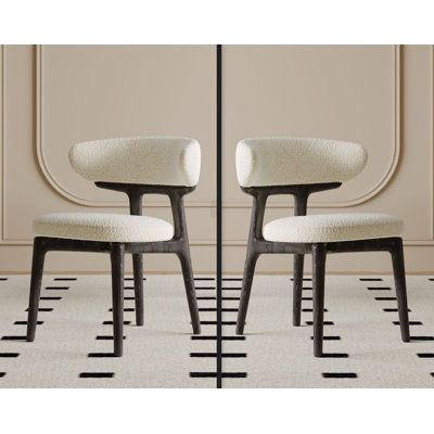 two chairs side by side in front of a beige wall with black lines on the floor