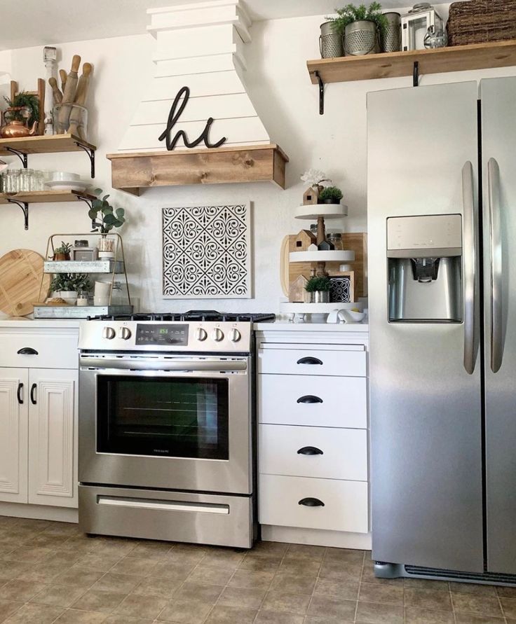 a kitchen with stainless steel appliances and open shelving on the wall above the stove