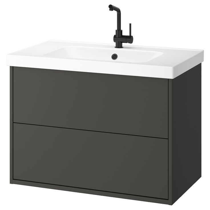 a bathroom sink with a black faucet on the side and a white counter top