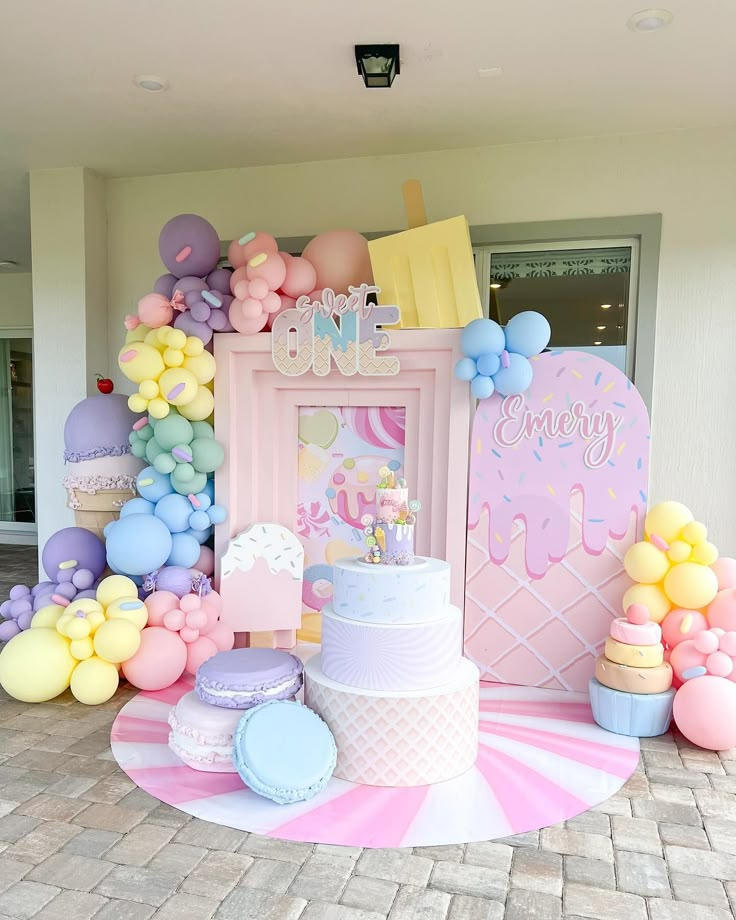 there is a cake and balloons on the table