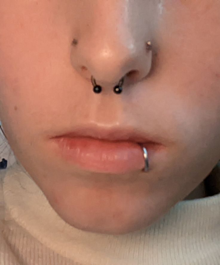 a woman with nose piercings on her nose