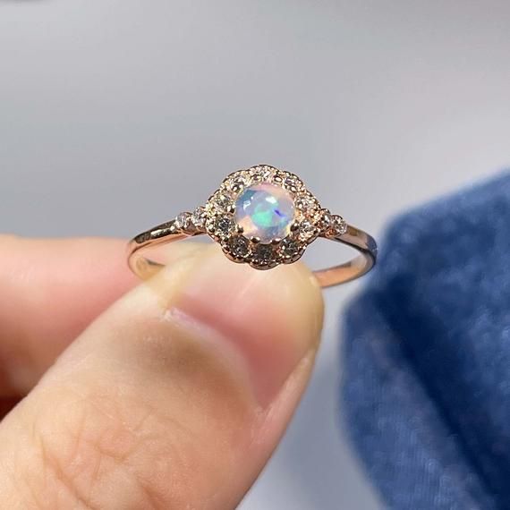 >>>> BASIC OPAL INFORMATION <<<< Round Opal : 5*5mm.Main stone: Natural good fire opal.Side stone: dainty cz diamond (cubic zircon).Material: 925 Sterling Silver +Natural opal stone.Metal color: silver, gold, rose gold. Metal materials: 925 sterling silver, 18K rose gold Plated, 18K rose gold Plated.>>>> SIMPLE DESIGN AND GOOD FIRE <<<>>> CUSTOM METALS <<<< Ring Size: From US #2 to US #15.Supply customized Solid Gold (9K, 14K and Diamond White Round Opal Jewelry, Rose Gold Pink Opal Round Jewelry, Rose Gold Pink Opal Jewelry, Fine Jewelry Opal Promise Ring, Elegant Pink Opal Moonstone Ring, Ethiopian Opal Ring For Wedding, Elegant Round Pink Opal Jewelry, Gold Opal Ring With Accent Stones, Elegant Opal Jewelry With Halo Setting