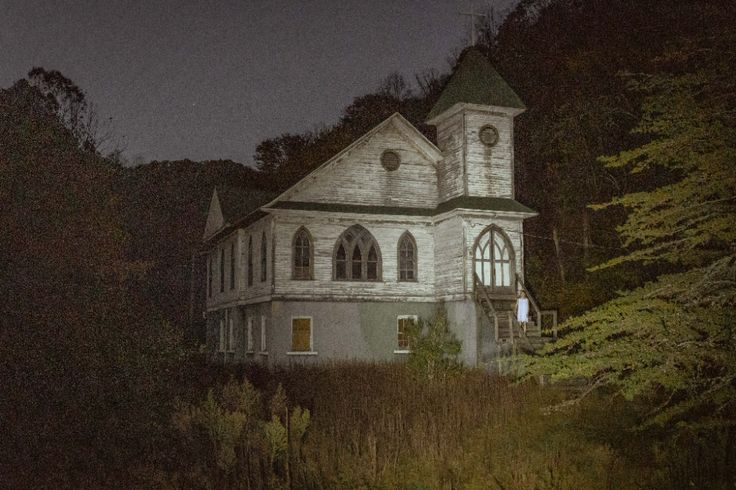 an old church in the woods at night