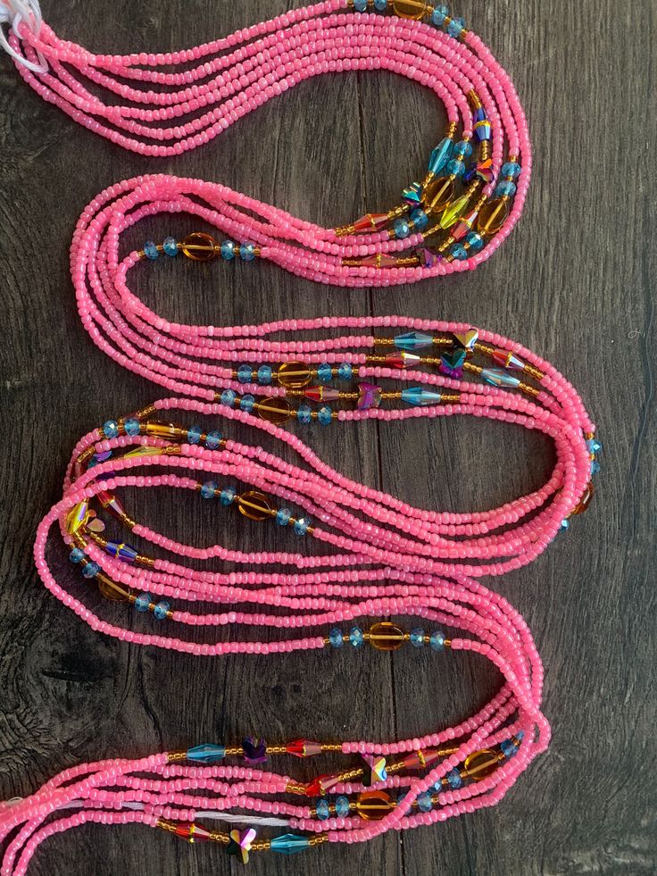 These beads come in TIE ON only, they are 45"- 50" long and self adjustable based on your waist size. ★ Please note, the Bead option you pick is exactly what you'll receive. ★ The listed prices are for one strand each. For multiple strands you'll have to indicate from the quantity section in your cart. Uses of Waist beads ★ Cultural and Spiritual Reasons ★Waist beads as ornaments as well as for symbolic adornment, ★ which serves as a sign of wealth, femininity or aristocracy, as well as spiritua Pink Beaded Necklace With 108 Beads For Beach, Adjustable Long Necklace With Round Beads For Festivals, Adjustable Pink Bohemian Waist Beads, Adjustable Pink Waist Beads For Festival, Pink Multi-strand Large Beads, Pink Hand-strung Beaded Necklaces For Beach, Pink Beaded Necklaces For Beach, Pink Hand-strung Beaded Necklaces For Festival, Pink Hand-strung Beaded Necklace For Beach