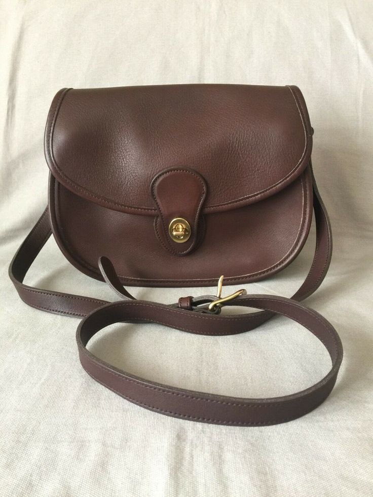 This Coach Prairie Bag is about 9 inches wide, 7 inches high, and 3 inches deep. Adjustable crossbody/shoulder strap. Outside back slide in pocket.  Pocket under flap. Inside zip pocket in main compartment. Will come in original box of 10-1/2 inches by 10-1/2 inches by 4-1/2 inches. The following Coach Creed is stamped on the zip pocket - "THIS IS A COACH BAG. IT WAS HANDCRAFTED IN THE UNITED STATES OF COMPLETELY NATURAL GLOVE TANNED COWHIDE . . . " No. L5L-9954. Vintage Bag Outfit, Coach Bag Outfit, Franciscan University, Coach Vintage Handbags, Chloe Bags Handbags, Saddle Bag Purse, Vintage Designer Bags, Handwoven Bag, Inside My Bag