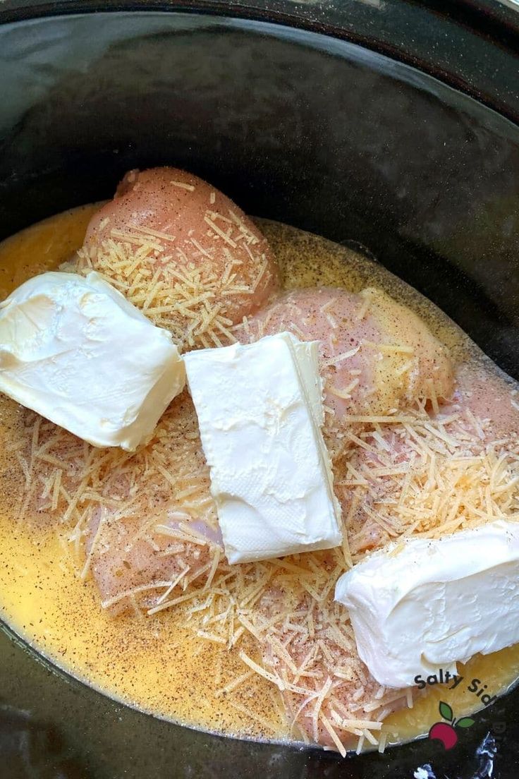 cheese and butter are being cooked in the slow cooker