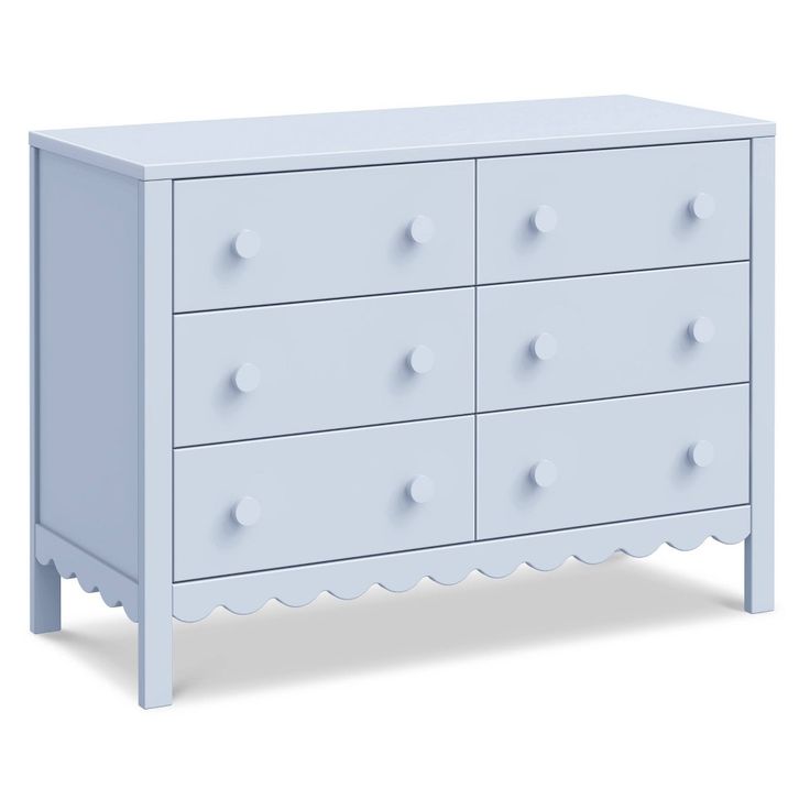 a white dresser with four drawers and two knobs on the top, in front of a white background