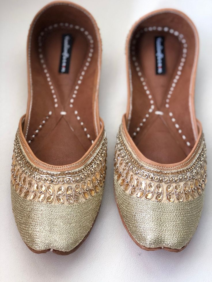 Timeless beauty is 'GRACEFUL GOLD' to be clubbed with any outfit to get the stunning glaze. This jutti with gold embroidery and beads is a contemporary classic pair of juttis which is a perfect accompaniment to just about anything. *Ethnic Shoes/Women Flats/Handmade Indian Designer Women Shoes or Slippers/Royal shoes/traditional style Women SPECIFICATIONS: *Upper/Panna - Gold fabric with embroidery, rhinestones and beads *Back/Adda - Gold fabric with embroidery, rhinestones and beads *Lining - L Festive Embellished Closed Toe Flats, Festive Embellished Closed-toe Flats, Festive Flats For Party, Festive Party Flats, Bollywood Style Festive Flats With Mirror Work, Bollywood Style Flats With Mirror Work For Festive Occasions, Embellished Flats For Festivals, Embellished Flats For Festive Occasions, Bollywood Style Flats With Mirror Work For Party