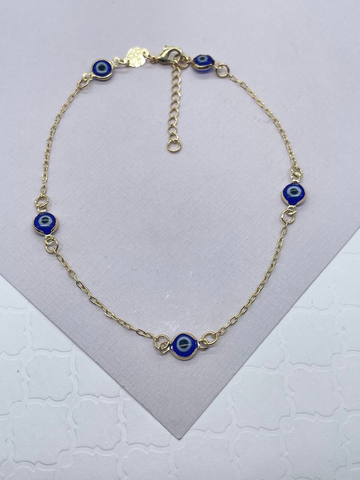 "18k Gold Filled Dainty Blue Color Evil Eye Anklet 10\" length + 1\" Extension Buy with confidence we add insurance to every shipping package. Our Etsy store was developed to help you find the most unique styles of modern designs, always looking for elegance and market trends. Here you will find ways to better make your jewelry through quality, seeking harmony, exclusivity and impeccable finish. Find many more styles in our Milie Jewelry Etsy Store. https://www.etsy.com/shop/miliejewelry You can Dainty Blue Round Evil Eye Bracelet, Blue Dainty Evil Eye Jewelry, Elegant Blue Anklets For Gift, Elegant Blue Anklets For Gifts, Adjustable Evil Eye Anklets As Gift, Dainty Gold Evil Eye Bracelet, Adjustable, Evil Eye Anklet, Gold-plated Evil Eye Bracelet With Adjustable Chain, Protection Jewelry