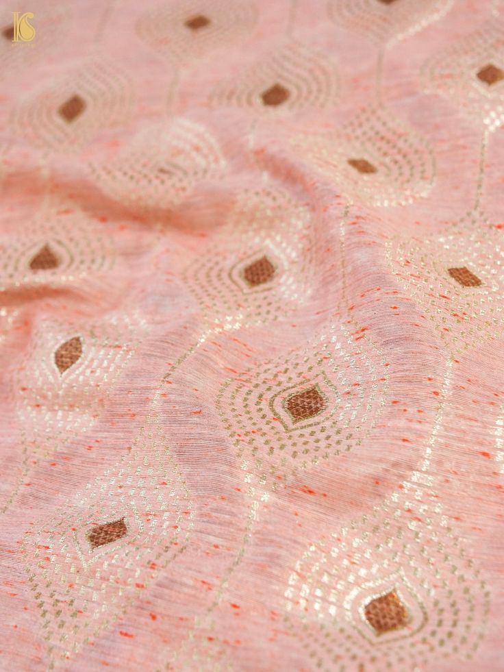 an image of a pink and gold fabric with small circles on the top of it