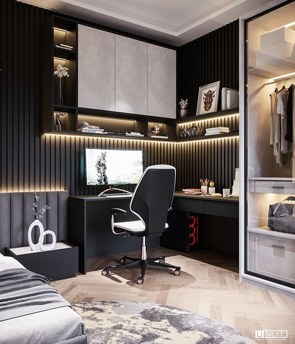 a bedroom with black and white walls, a desk and chair in front of the bed