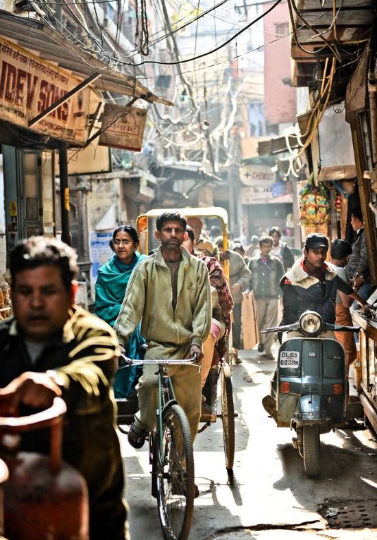 a group of people riding bikes down a street