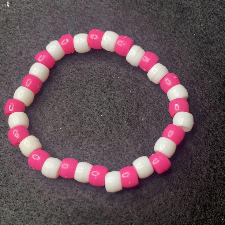 Material: Clear string Color: Pink and blue beads Type: Bracelet Style: Casual Pink Adjustable Crystal Bracelet With Round Beads, Adjustable Pink Crystal Bracelet With Round Beads, Adjustable Pink Pearl Bracelet With Spacer Beads, Bohemian Pink Beaded Pearl Bracelet, Pink Pearl Bracelet With Colorful Beads, Pink Beaded Pearl Bracelet With Round Beads, Pink Bohemian Stretch Bracelet With Round Beads, Pink Beaded Pearl Bracelet, Pink Crystal Bracelet With Letter Beads