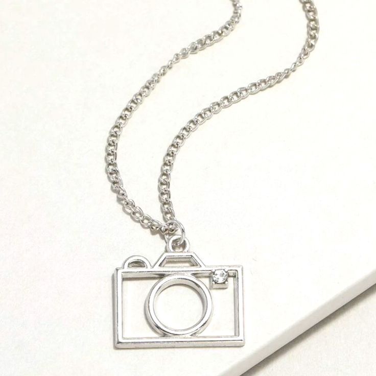 Silver Camera Necklace For Sale! This Necklace Is So Cute! It Features A Silver Camera Charm With A Little Crystal In Place, For The Flash! It Has An Adjustable Silver Chain. It Is New, Never Been Worn, And It’s From My Boutique! Such A Cute Necklace To Add To Your Jewelry Collection! Camera Charm, Camera Necklace, Boho Pendant Necklace, Sterling Silver Heart Necklace, Bubble Necklaces, Star Pendant Necklace, Silver Heart Necklace, Cute Necklace, Silver Accessories