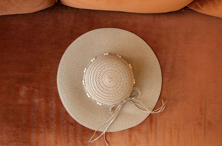 Block the rays in the most stylish of ways! Our BOHEMIAN hat comes in a natural tan woven texture. A straw beaded band tops off the look. Decorate your Summer outfits with a lightweight touch! Measurements: 4��” Brim, 3.5” Crown Depth, 7.5” Head Diameter Material: 100% paper Beige Woven Sun Hat For Beach, Adjustable Cream Woven Sun Hat, Cream Woven Hat For Summer, Adjustable Woven Crochet Hat In Beige, Beige Woven Sun Hat For Festival, Casual Beaded Fedora Sun Hat, Adjustable Cream Straw Hat For Vacation, Summer Braided Beige Panama Hat, Bohemian Cream Straw Hat For Summer